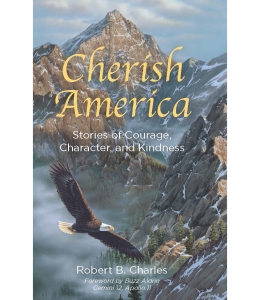 The cover of the book Cherish America: Stories of Courage, Character, and Kindness by Robert B. Charles, foreword by Buzz Aldrin Gemini 12, Apollo 11, featuring an image of a bald eagle soaring over a snow-covered mountain range.